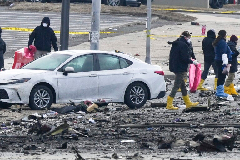 Investigators work the scene after a small plane crashed in Philadelphia, Saturday, Feb. 1, 2025. (AP Photo/Matt Rourke)