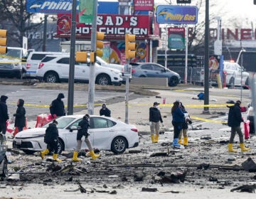 Investigators work the scene after a small plane crashed in Philadelphia, Saturday, Feb. 1, 2025. (AP Photo/Matt Rourke)