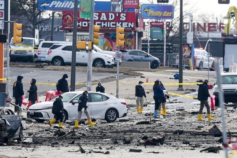 Investigators work the scene after a small plane crashed in Philadelphia, Saturday, Feb. 1, 2025. (AP Photo/Matt Rourke)