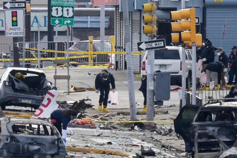 Investigators work the scene after a small plane crashed in Philadelphia, Saturday, Feb. 1, 2025. (AP Photo/Matt Rourke)