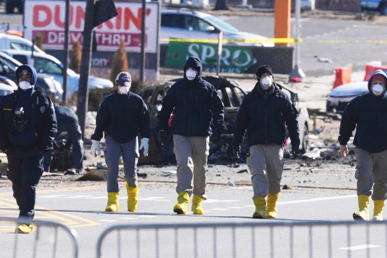 Investigators work the scene where a small plane crashed in Philadelphia, Saturday, Feb. 1, 2025. (AP Photo/Matt Rourke)