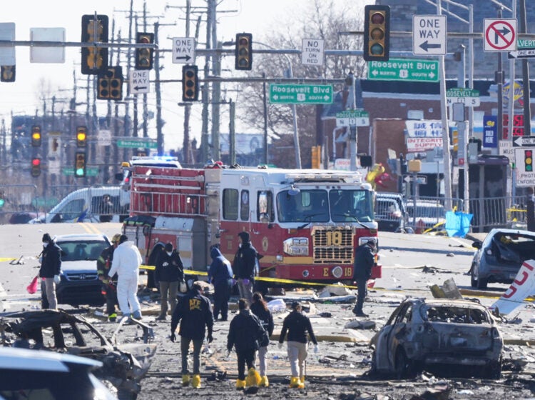 Investigators on the ground at the site of the plane crash