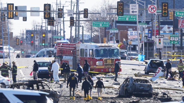 Investigators work the scene where a small plane crashed in Philadelphia, Saturday, Feb. 1, 2025. (AP Photo/Matt Rourke)