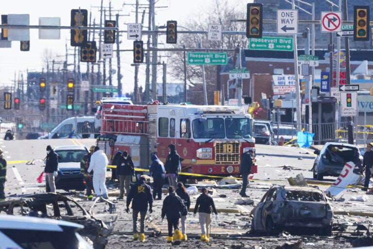 Investigators work the scene where a small plane crashed in Philadelphia, Saturday, Feb. 1, 2025. (AP Photo/Matt Rourke)