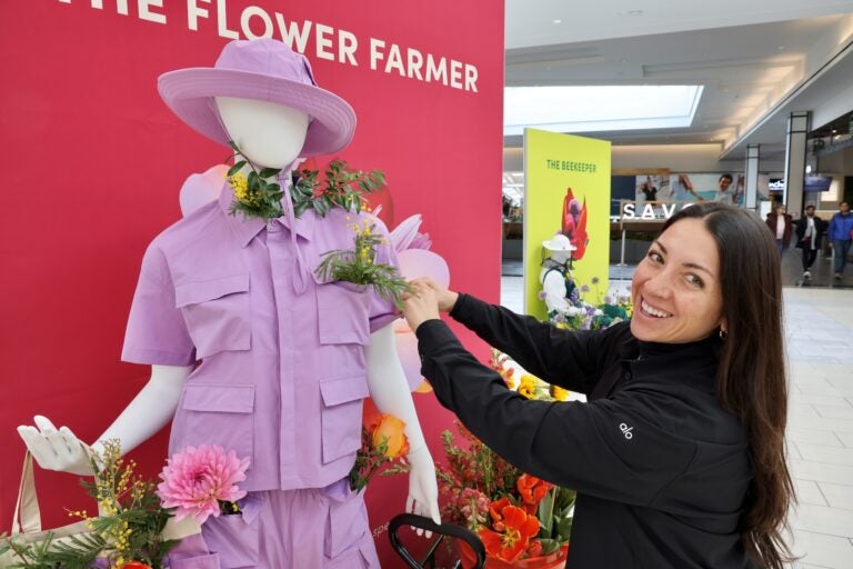 Liz Barrella smiles in front of a display