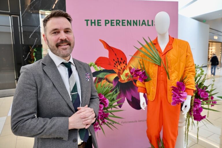 Seth Pearsol smiles in front of a display