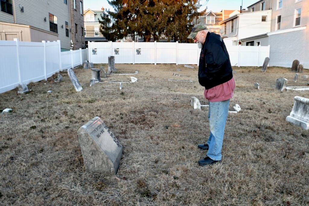 Joseph Menkevich looks at a grave marker