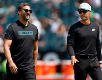 FILE - Philadelphia Eagles head coach Nick Sirianni, left, talks with assistant head coach Kevin Patullo during warmups before an NFL pre-season football game against the Minnesota Vikings, Saturday, Aug.24, 2024, in Philadelphia. (AP Photo/Rich Schultz, File)