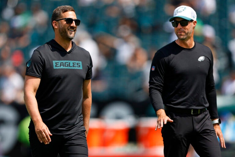 FILE - Philadelphia Eagles head coach Nick Sirianni, left, talks with assistant head coach Kevin Patullo during warmups before an NFL pre-season football game against the Minnesota Vikings, Saturday, Aug.24, 2024, in Philadelphia. (AP Photo/Rich Schultz, File)