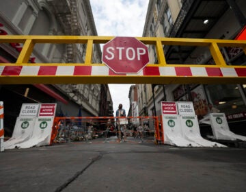 Newly installed security barriers are seen on Bourbon Street next to a memorial for victims of the Jan. 1 car attack ahead of the Super Bowl in New Orleans, Friday, Jan. 31, 2025. (AP Photo/Gerald Herbert)