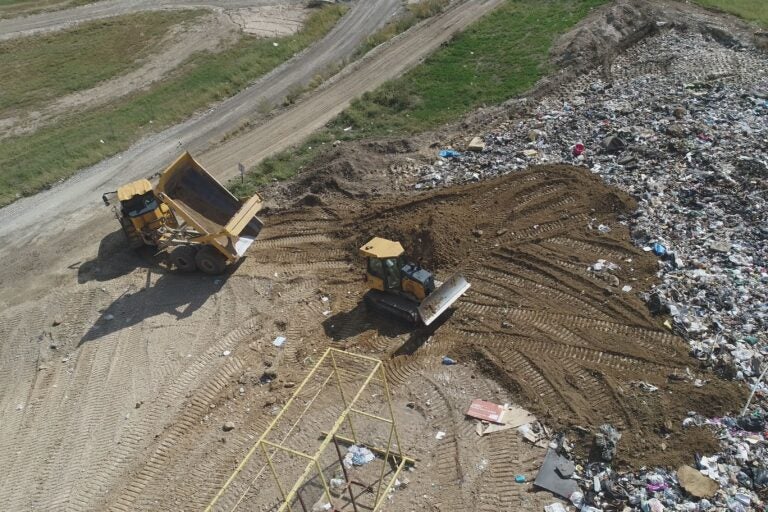 two bulldozers on the site of the landfill