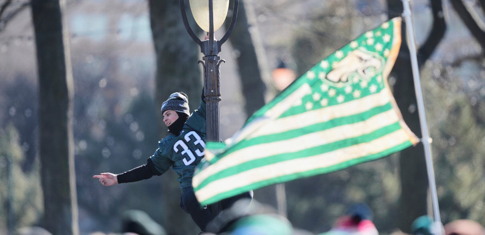 A fan hangs from a lamp post