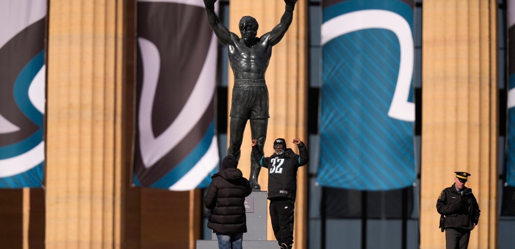 A man poses with the Rocky statue