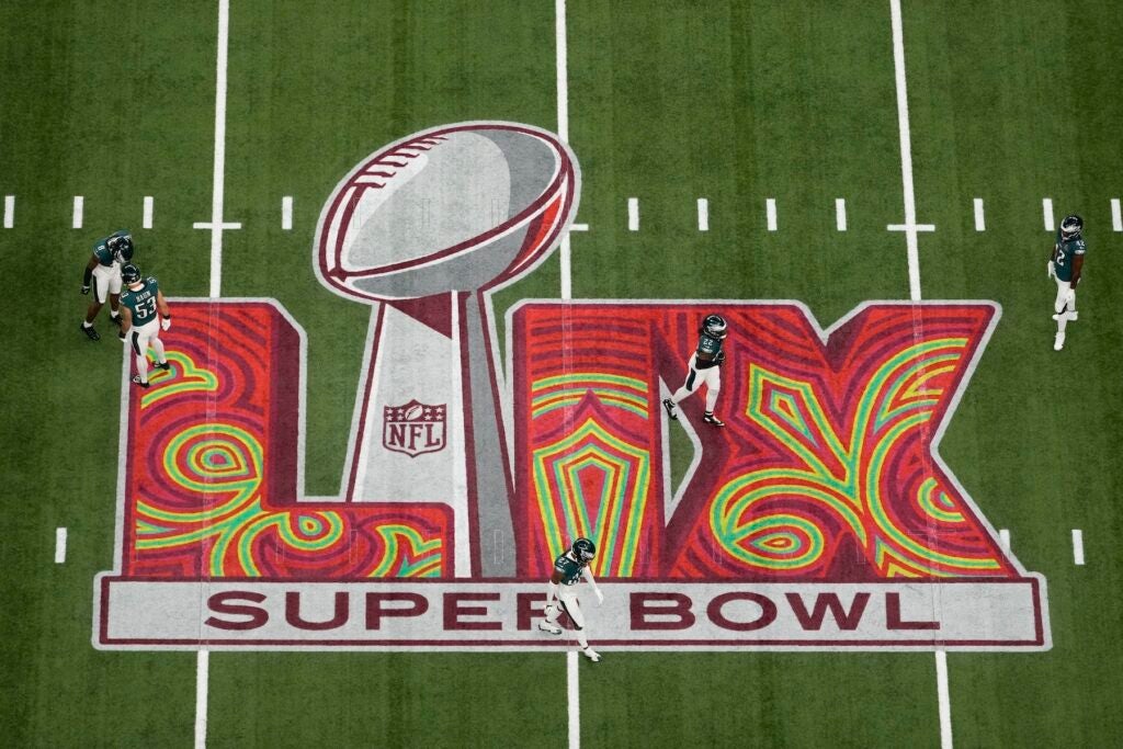 Eagles players warm up on the field before Super Bowl 59