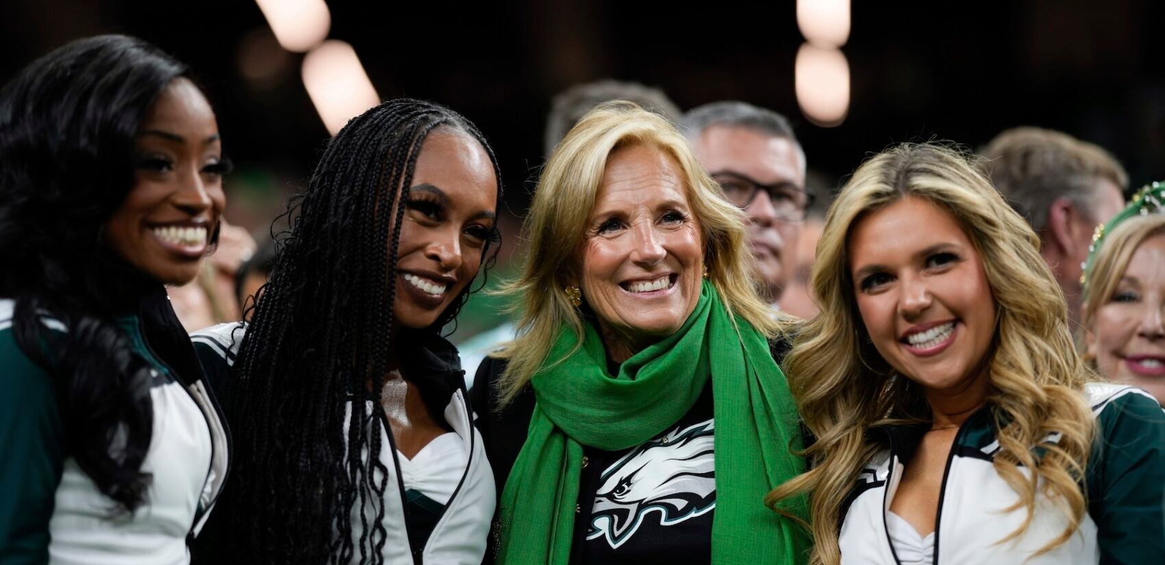 Dr. Jill Biden posing for a photo with Eagles cheerleaders