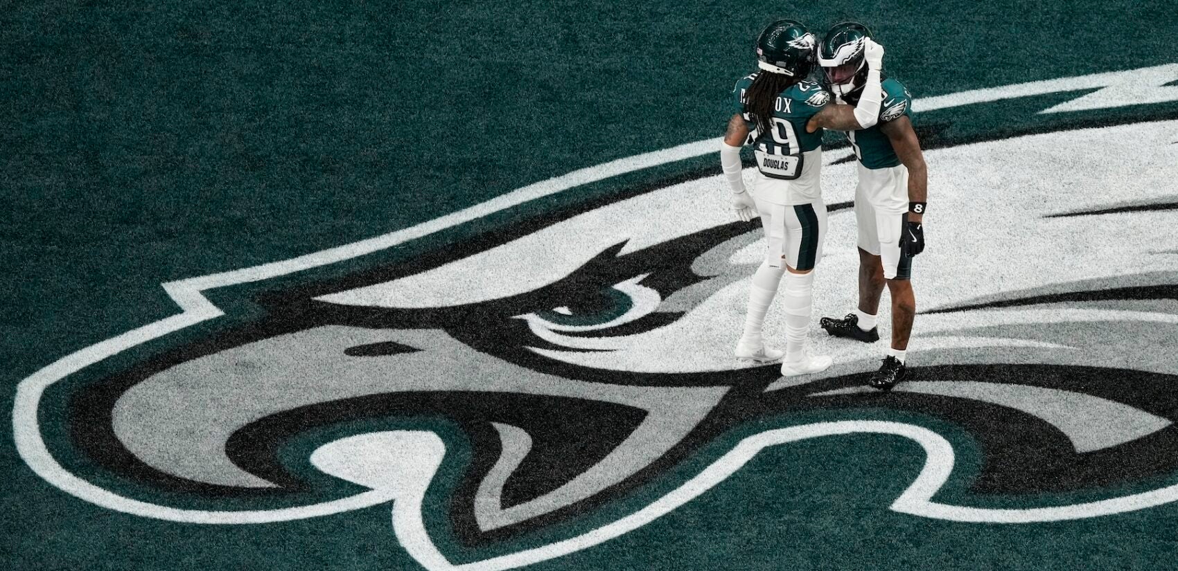 Eagles players warm up on the field before Super Bowl 59