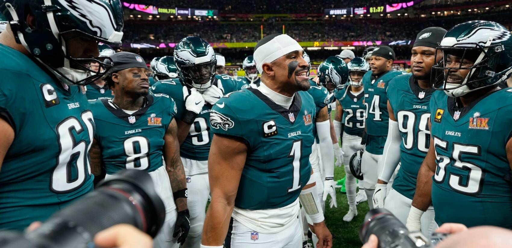 Jalen Hurts speaking to teammates in a huddle before the game