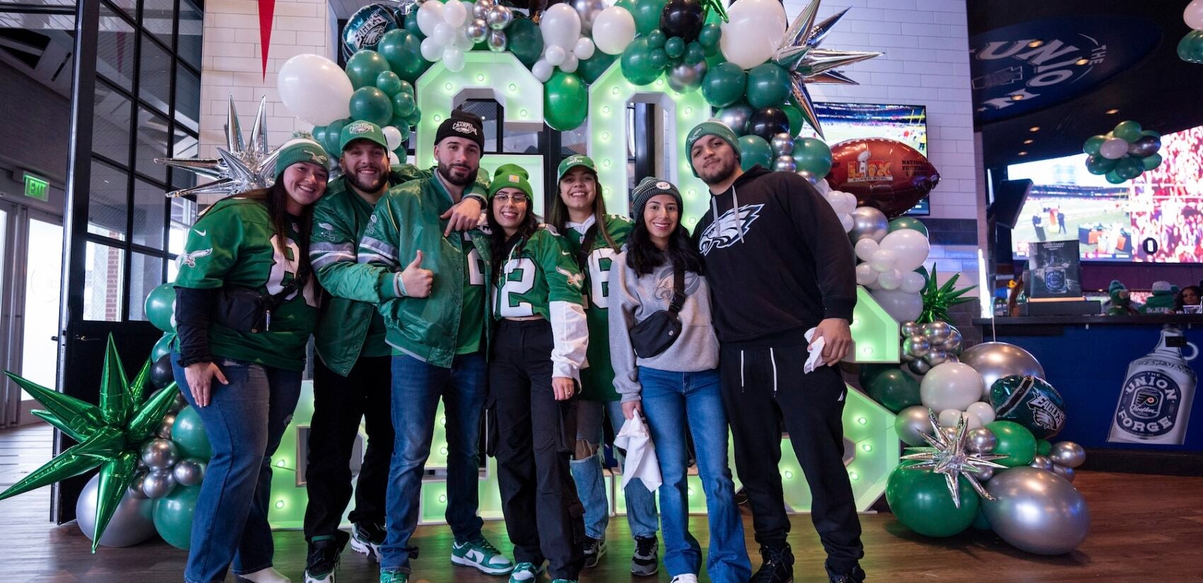 Eagles fans pose at a watch party