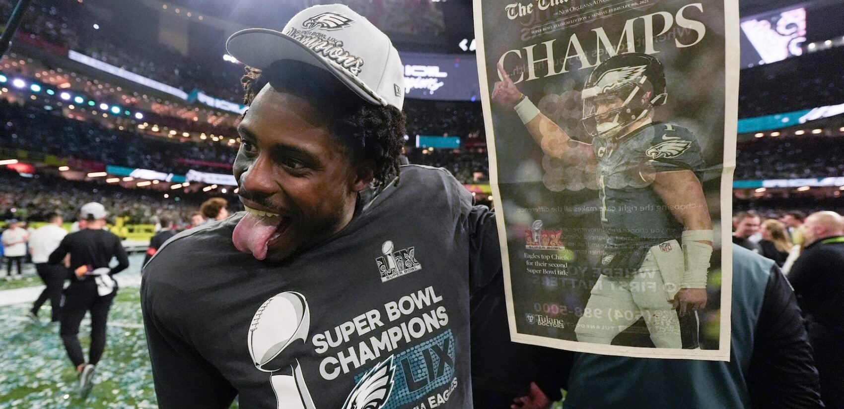 C.J. Gardner-Johnson holds a newspaper after winning the Super Bowl