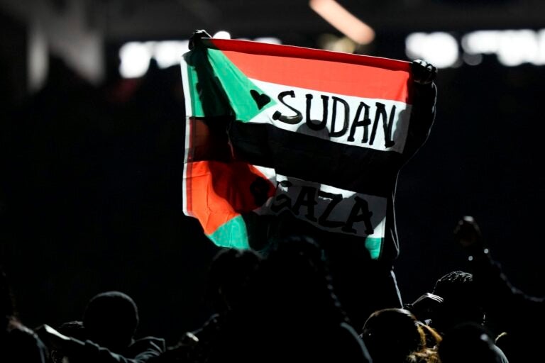 A Sudanese flag is held up during half time