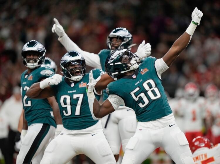 Jalyx Hunt Eagles players celebrating on the field after sacking Mahomes