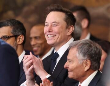 Elon Musk smiling and clapping