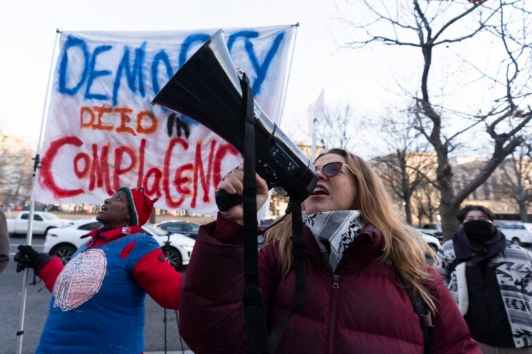 Carrie Muniak joins a rally in front of the Office of Personnel Management, Monday, Feb. 3, 2025, in Washington. President Donald Trump is relying on a relatively obscure federal agency to reshape government. The Office of Personnel Management was created in 1979 by President Jimmy Carter and is the equivalent of the government's human resources department. It helps manage the civil service, including pay schedules, health insurance and pension programs. The agency has offered millions of federal workers eight months of salary if they voluntarily choose to leave their jobs by Feb. 6.  (AP Photo/Manuel Balce Ceneta)