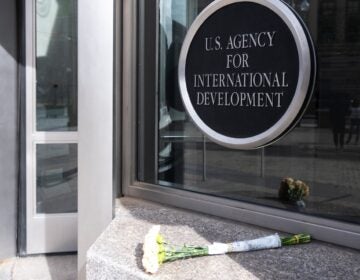 A bouquet of white flowers placed outside the headquarters of the United States Agency for International Development