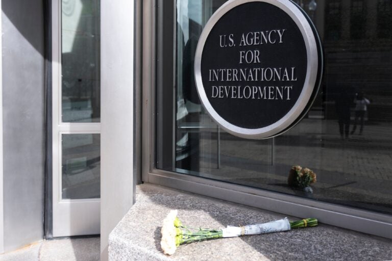 A bouquet of white flowers placed outside the headquarters of the United States Agency for International Development