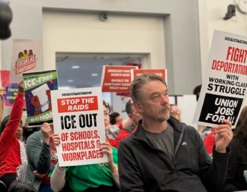 Advocates hold up signs