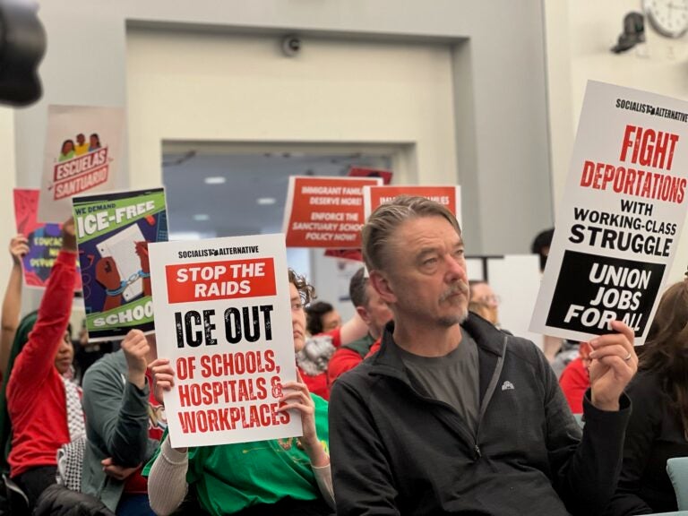 Advocates hold up signs