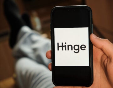 A Hinge logo appears on the screen of smartphone. (Bigstock/Vladimka)