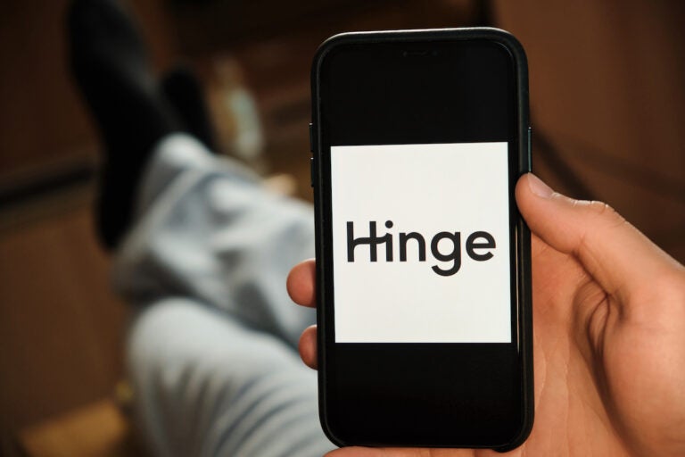 A Hinge logo appears on the screen of smartphone. (Bigstock/Vladimka)