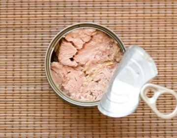 A can of tuna sits open