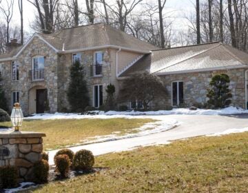 A large suburban home shown in the winter