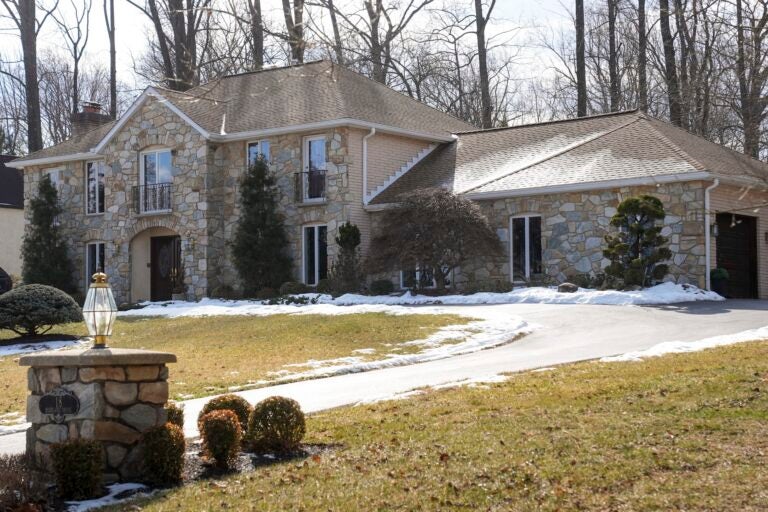 A large suburban home shown in the winter