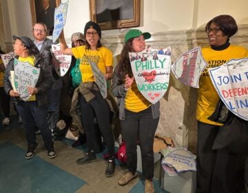 people holding signs for workers rights