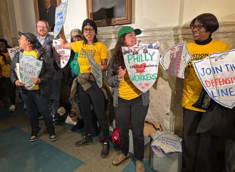 people holding signs for workers rights