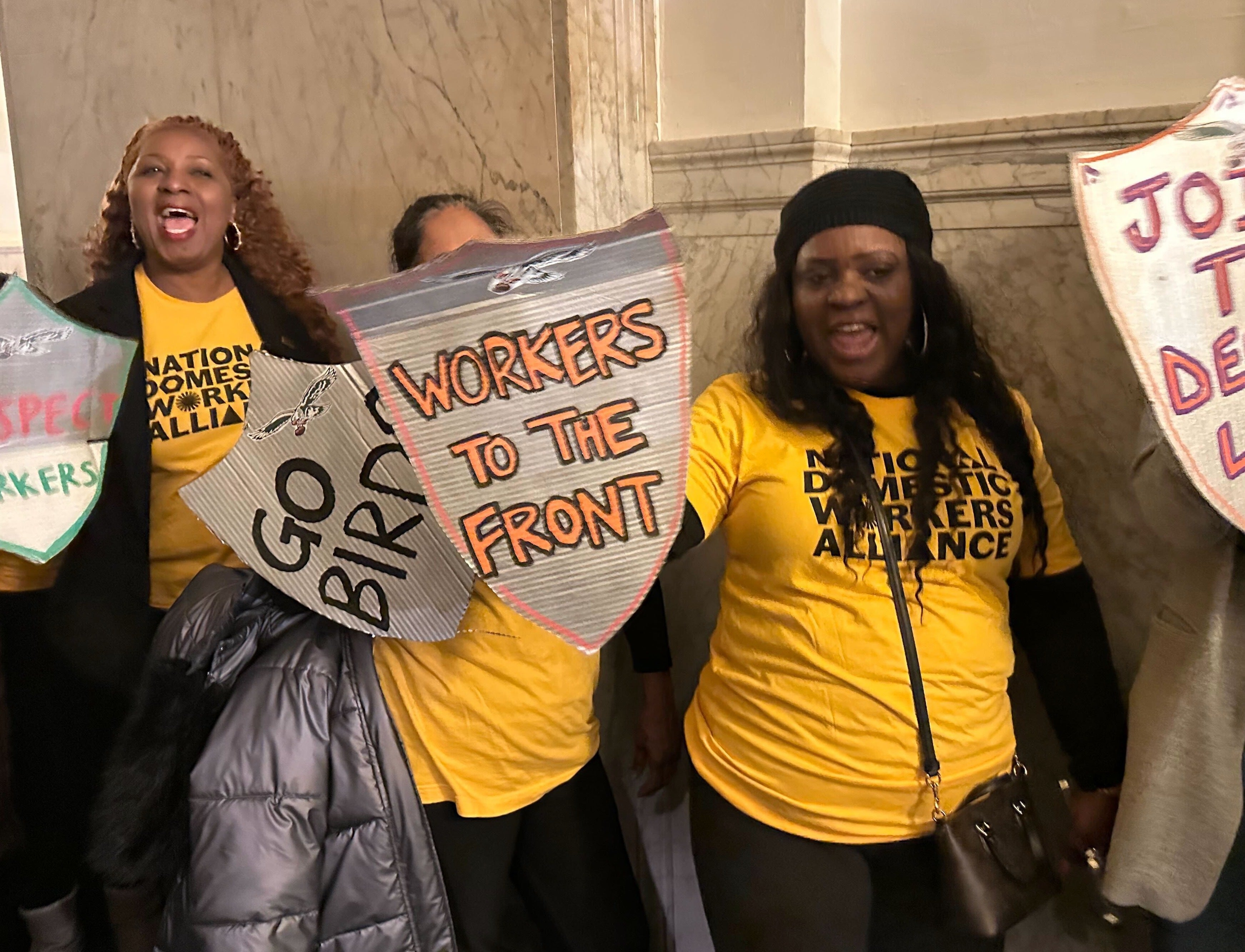 people holding signs for workers rights