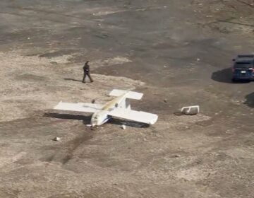 an overturned plane in a parking lot