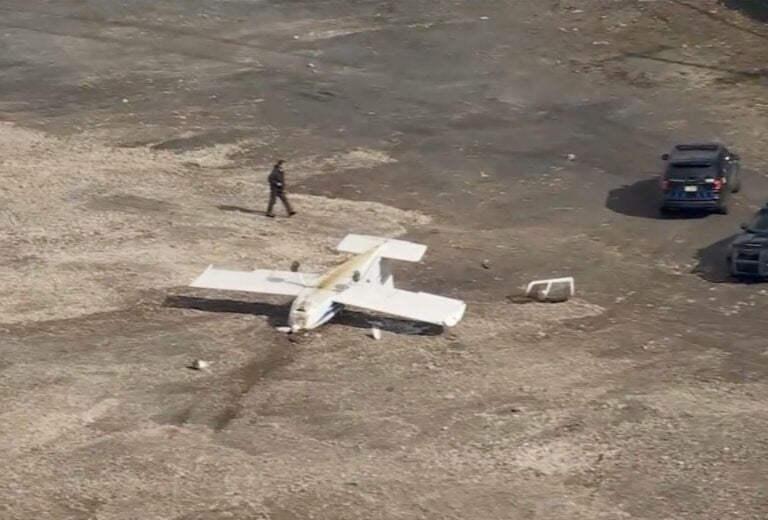 an overturned plane in a parking lot