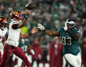 Commanders QB Jayden Daniels is pressured by Eagles defensive tackle Milton Williams