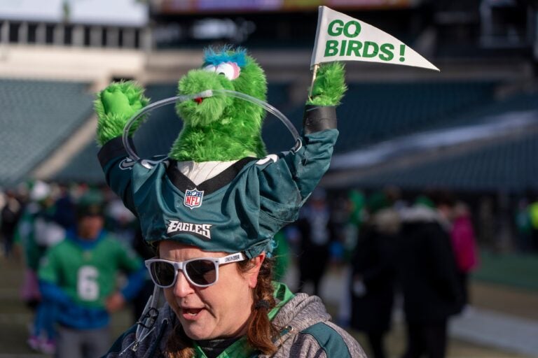 an Eagles fan with a Phillie Phanatic hat