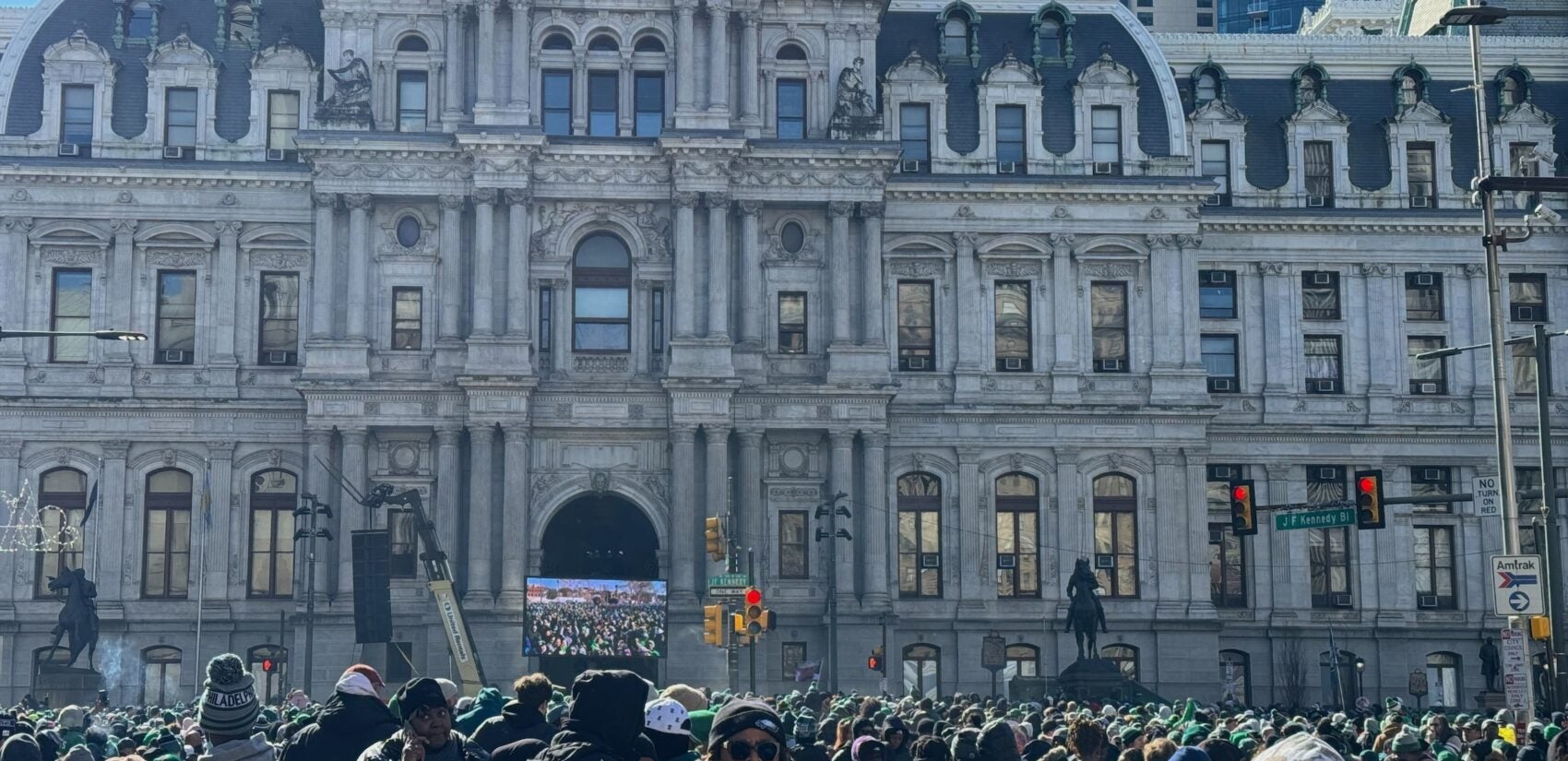 A crowd of people outside City Hall