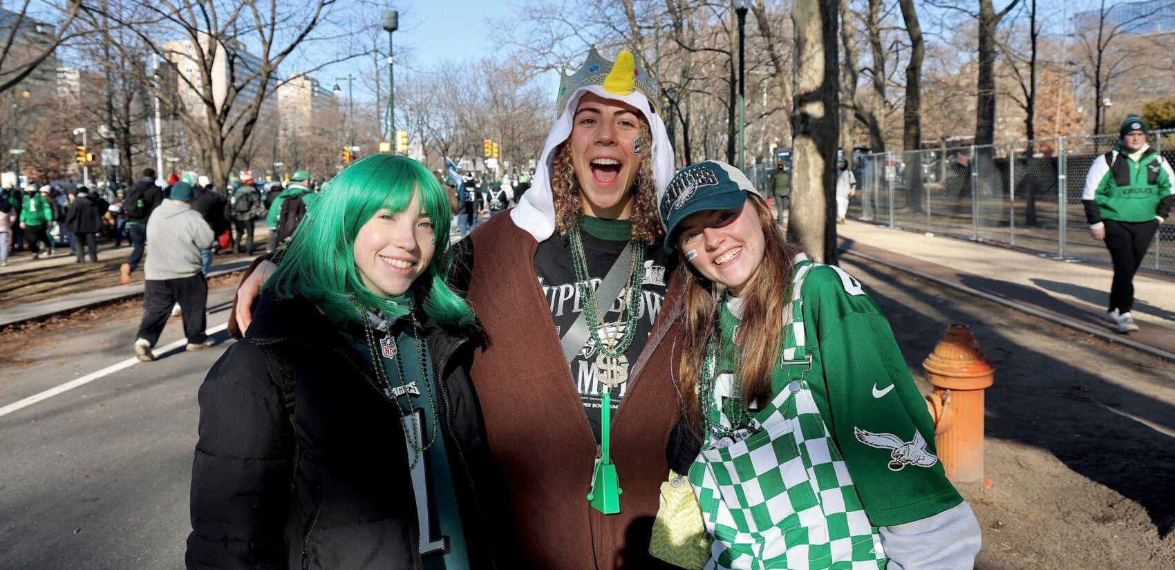 3 Eagles fans posing on the Parkway before the parade starts