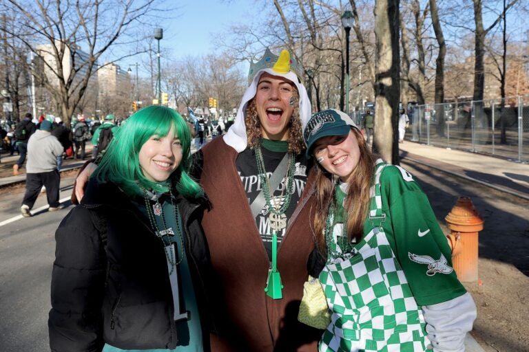 3 Eagles fans posing on the Parkway before the parade starts