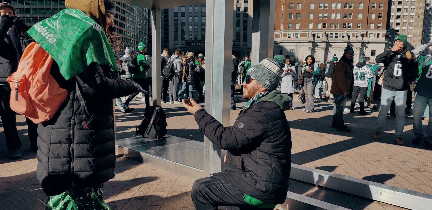 A man is on one knee proposing to a woman