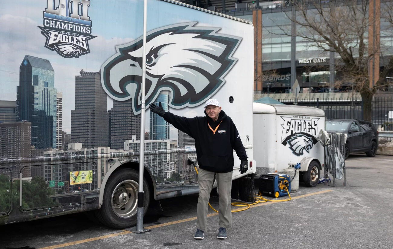 Tailgate host Ed Callahan poses in front of his Eagle Mobile II before the NFC championship game in Philadelphia