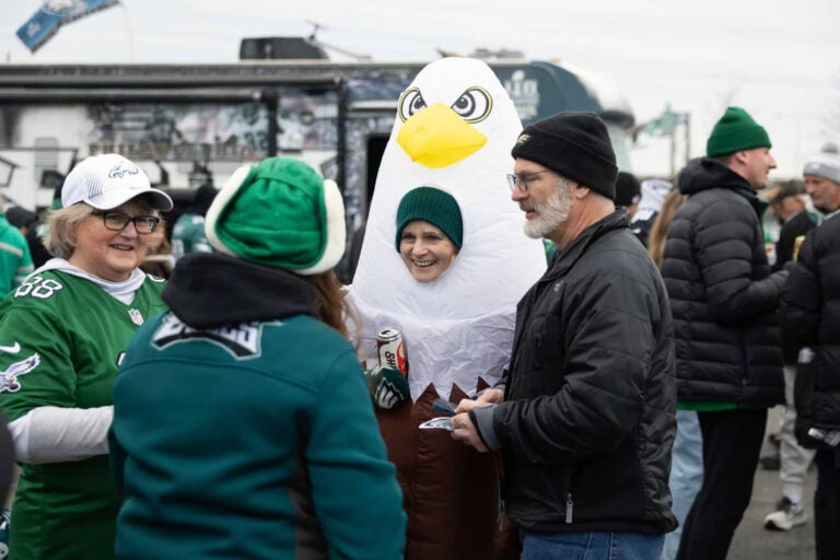 Susan Klabunde (center) dons an eagle costume at a tailgate before the NFC championship game at Lincoln Financial Field in Philadelphia. (Rachel Wisniewski/for NPR)