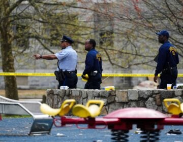 Investigators walking through the scene